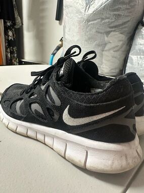 Nike Free Run 2 sneakers in black, white, and dark grey  MSRP$110
